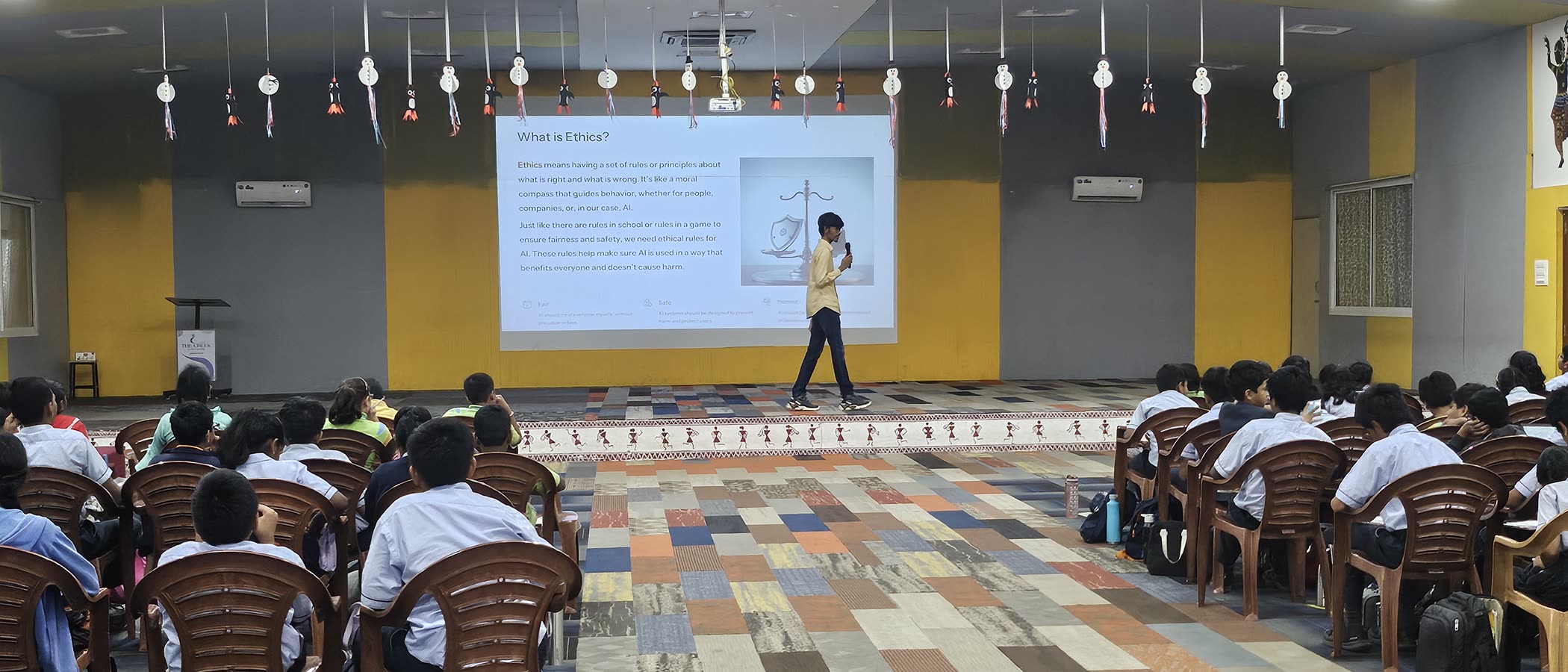 Students at an AI session, with a slide explaining why AI needs ethical rules